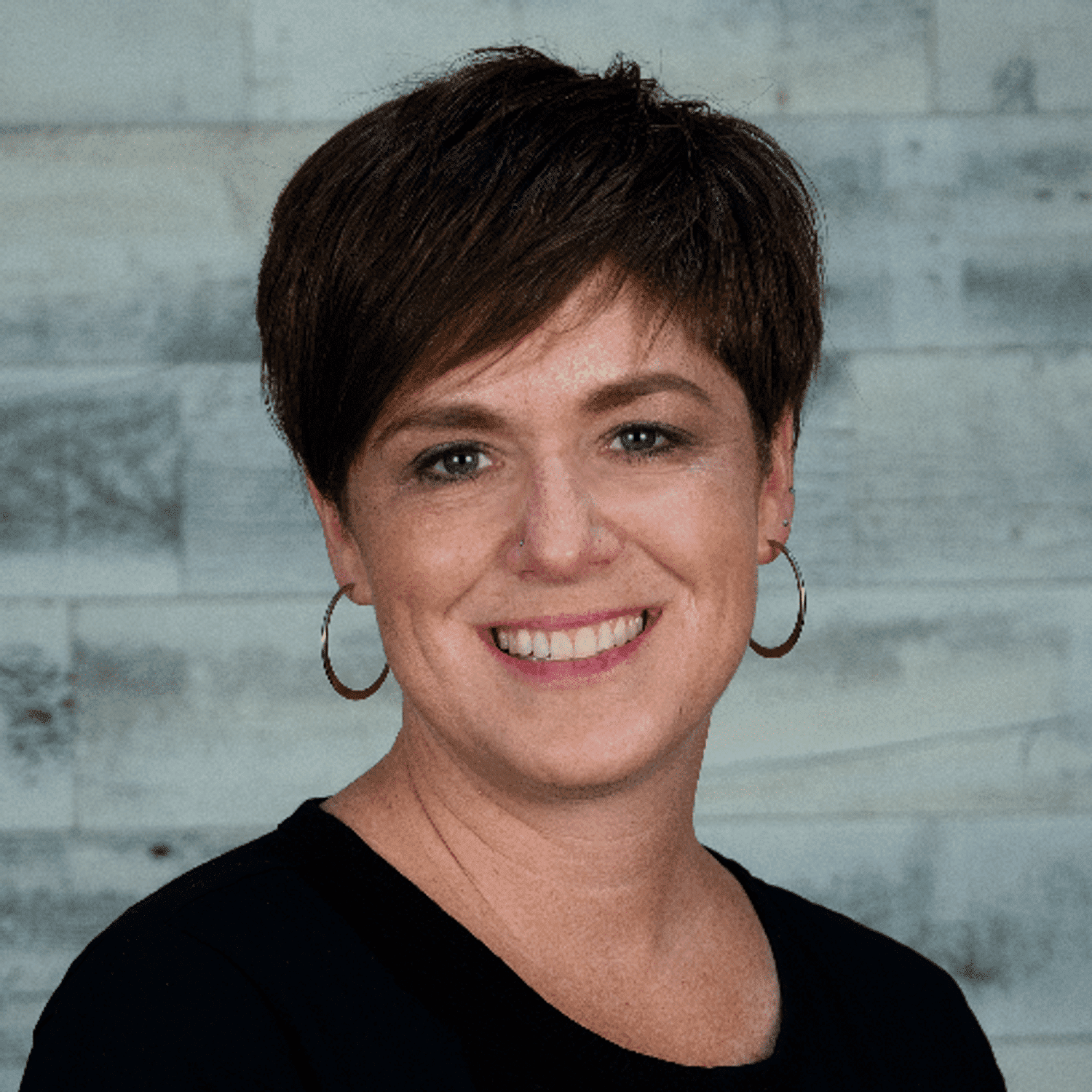 Portrait of Aimee, a professional stylist at Spark Salon, showcasing their expertise and style.