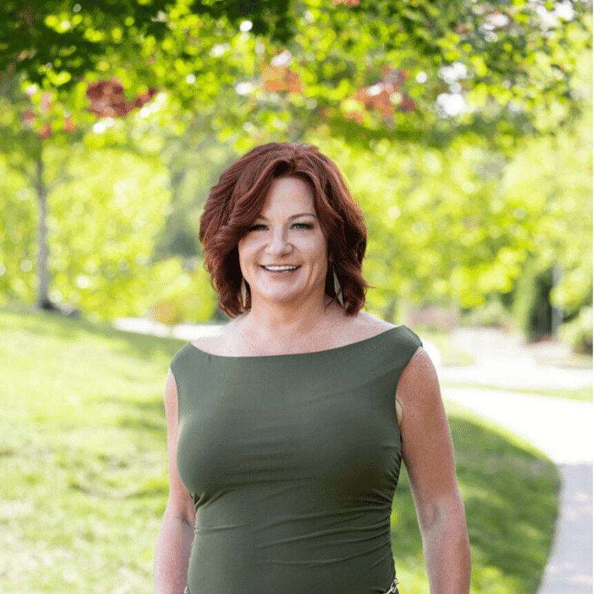Portrait of Dee, a professional stylist at Spark Salon, showcasing their expertise and style.