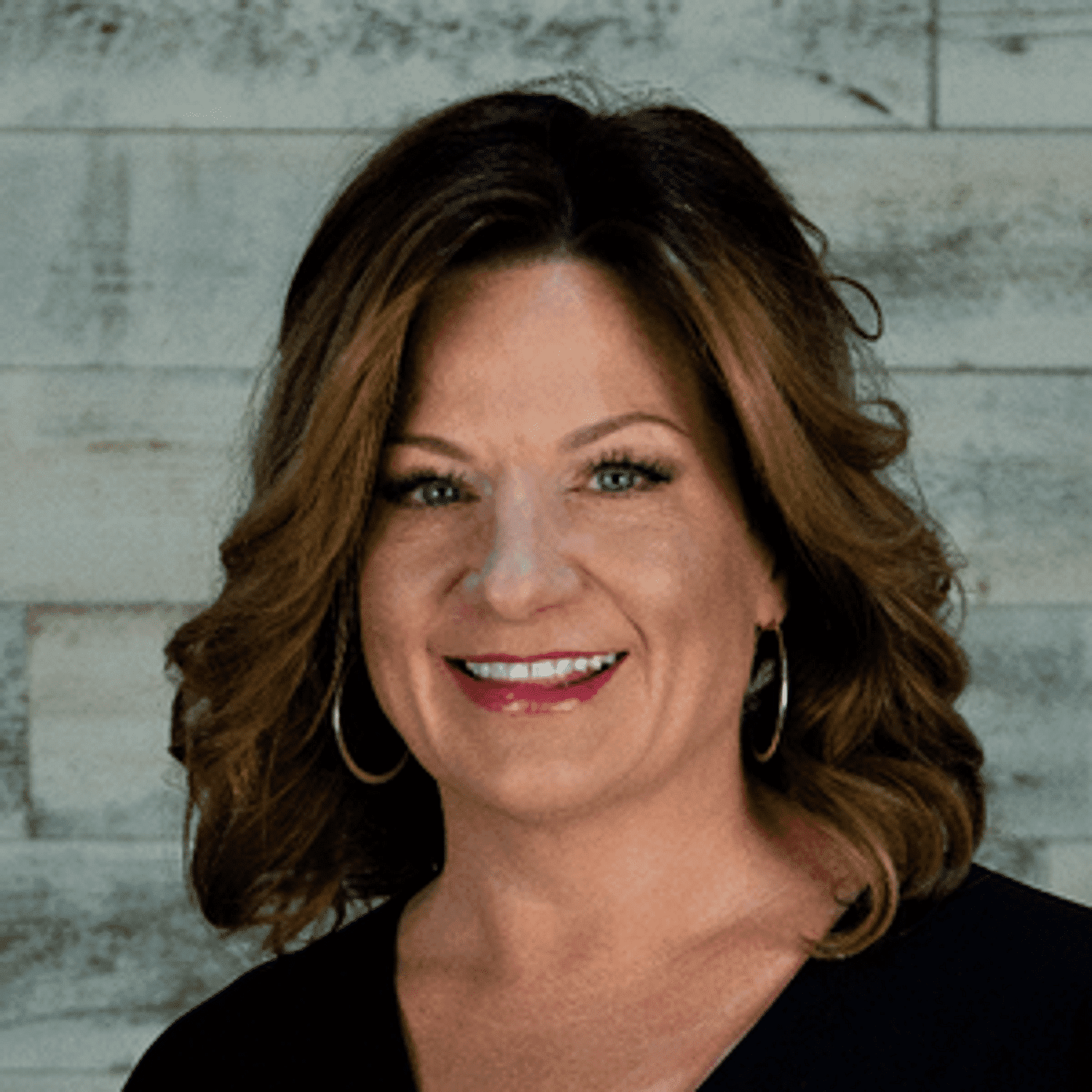 Portrait of Dee, a professional stylist at Spark Salon, showcasing their expertise and style.